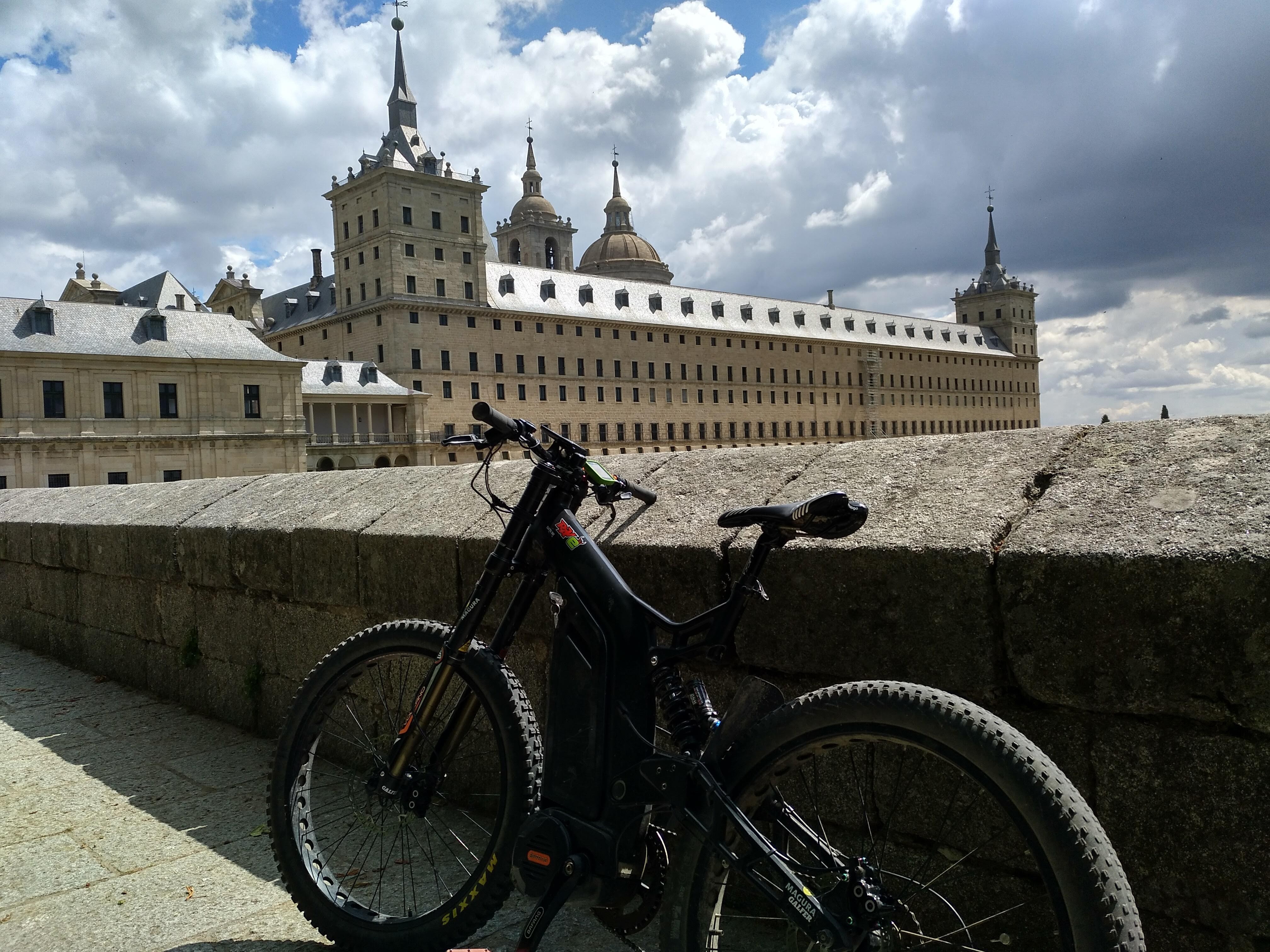 Electric mountain bike in front of the Monastery of San Lorenzo de El Escorial